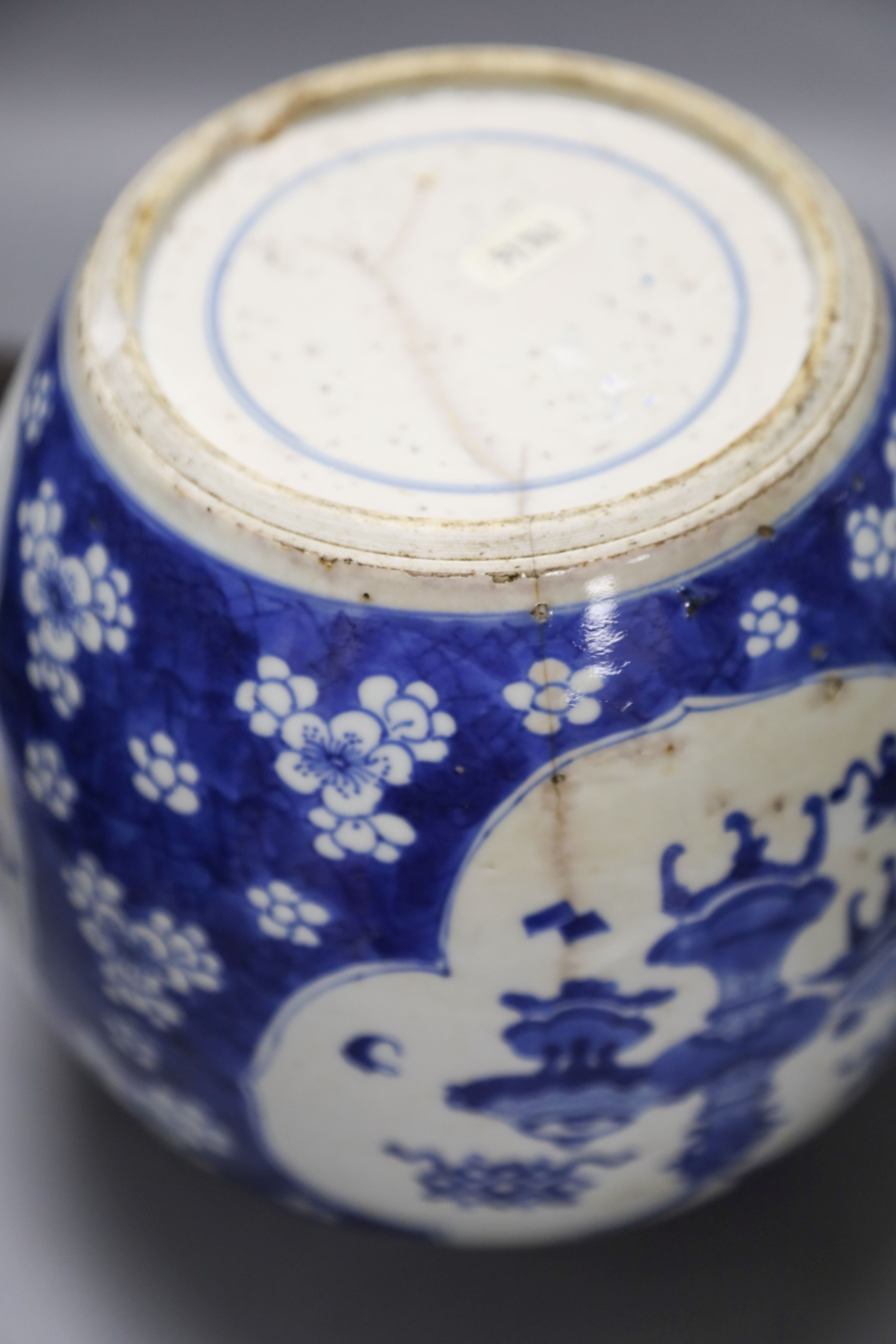 A Chinese Kangxi blue and white hundred antiques jar, 21cm, cracked, with hardwood stand and a Samson powder blue jar, 26cm, wear